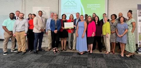 A gathering of staff and representatives celebrate Greenville Housing Fund's membership in the NeighborWorks network.