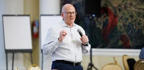 NeighborWorks Capital's Jim Peffley talks to a group during the NeighborWorks Executive Symposium.